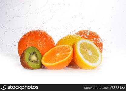 kiwi, lemon and orange on white background