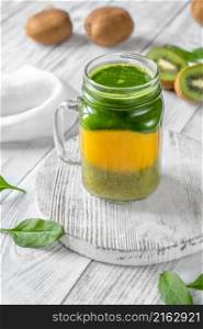 Kiwi, mango and spinach smoothie in mason jar