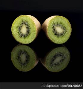 Kiwifruit on Black Reflective Background