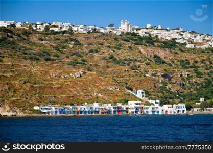 Klima and Plaka villages with whitewhashed traditional houses and orthodox church and windmills on Milos island, Greece. Klima and Plaka villages on Milos island, Greece