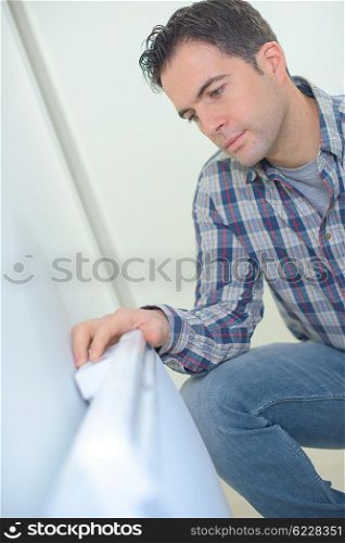 Kneeling by a radiator