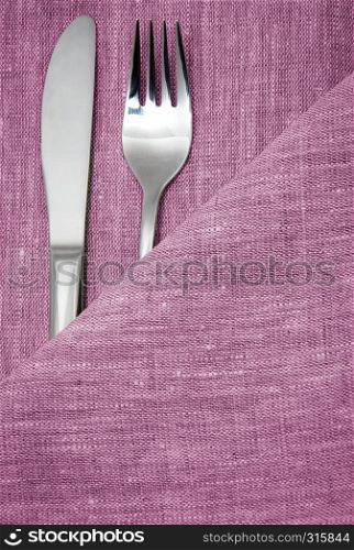 knife and fork in textile napkin