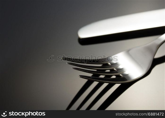 knife and fork on black background