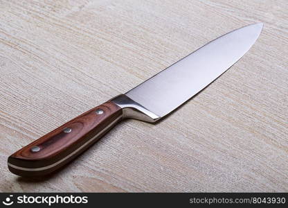 Knife on rustic kitchen table with copy space