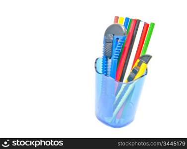 knifes and pencils in container on white background
