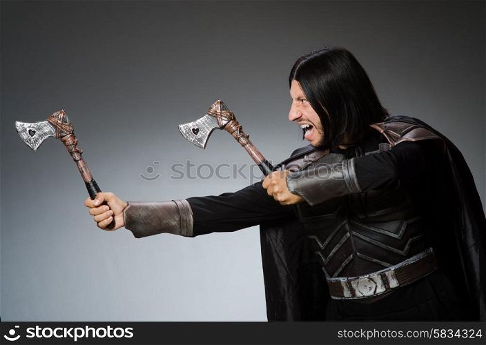 Knight with axe against dark background
