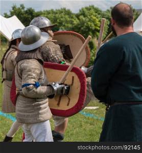 Knights in Battle with Silver Helmets and Armors: Medieval Event Reconstruction. Knights in Battle with Silver Helmets and Armors