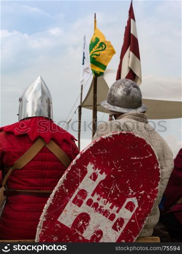 Knights with Silver Helmets and Shields seated on Chair: Medieval Event Reconstruction