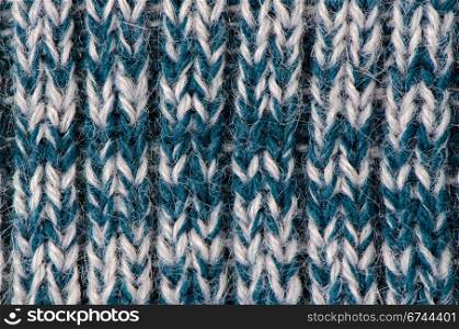 Knit woolen texture. Fabric blue and white background.