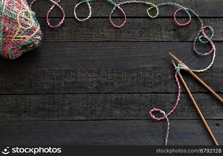 Knitted background with knitting needle and ball of yarn, knit is hobby, leisure activities of many people in free time, also make many handmade product