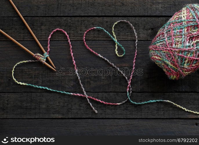 Knitted background with knitting needle and ball of yarn, knit is hobby, leisure activities of many people in free time, also make many handmade product