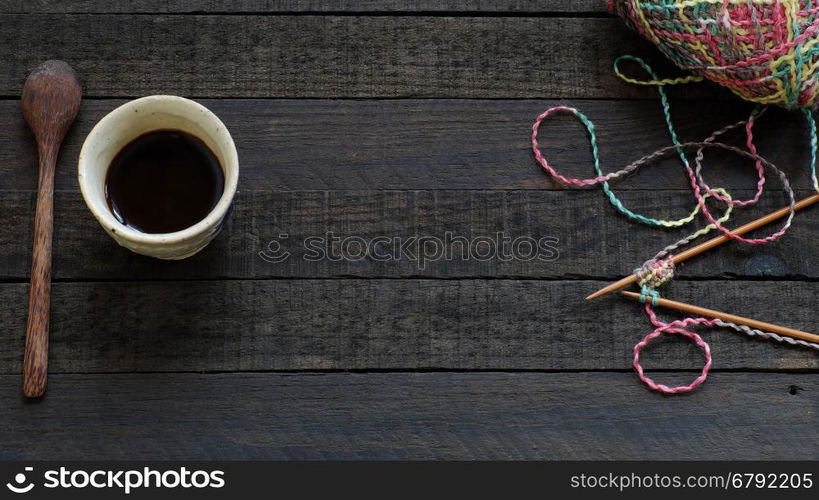 Knitted background with knitting needle, yarn and coffee cup, knit is hobby, leisure activities of many people in free time, also make many handmade product