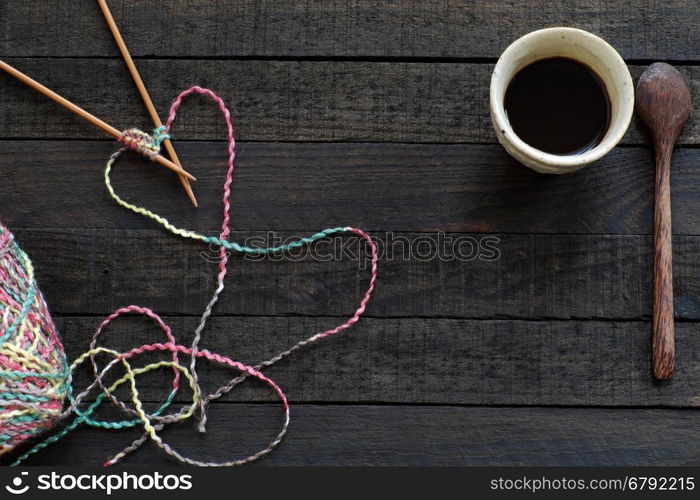 Knitted background with knitting needle, yarn and coffee cup, knit is hobby, leisure activities of many people in free time, also make many handmade product