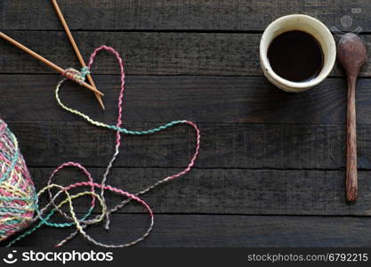 Knitted background with knitting needle, yarn and coffee cup, knit is hobby, leisure activities of many people in free time, also make many handmade product