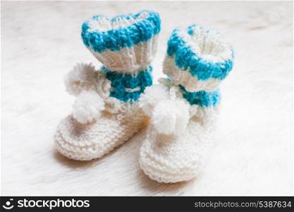 Knitted blue baby booties for little boy
