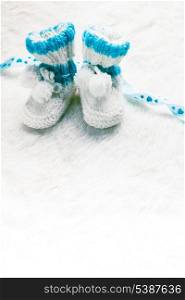 Knitted blue baby booties for little boy