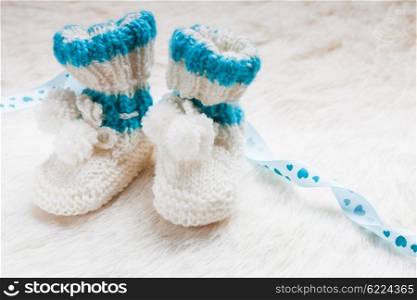 Knitted blue baby booties for little boy. Knitted baby booties