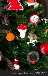 Knitted christmas toys on the christmas tree
