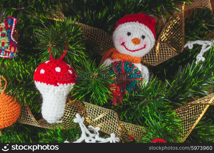 Knitted christmas toys on the christmas tree. The Knitted toys