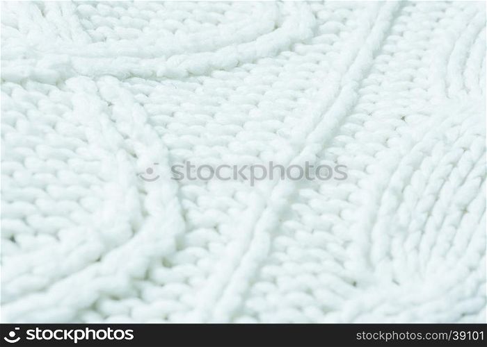 knitted fabric texture. Knitted jersey background with a relief pattern. Braids in knitting