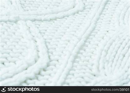 knitted fabric texture. Knitted jersey background with a relief pattern. Braids in knitting