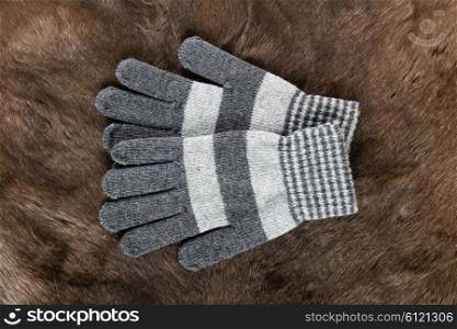 Knitted gloves on the background of fur