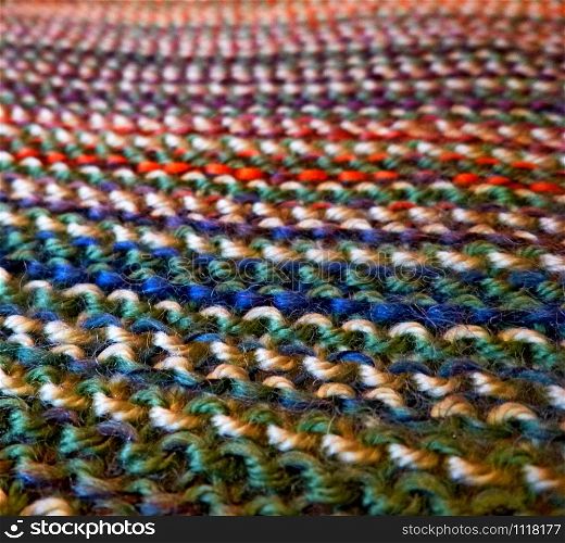 Knitted multicolored fabric texture. Background image Close-up. Hobbies, leisure. Knitting. Knitted multicolored fabric. Knitting texture. Close-up. Background image. Hobbies, leisure, crafts.