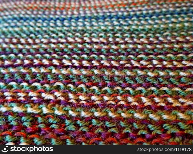 Knitted multicolored fabric texture. Background image. Hobbies, leisure, crafts Horizontal arrangement. Knitting. Knitted multicolored fabric. Knitting texture. Background image. Hobbies leisure crafts.