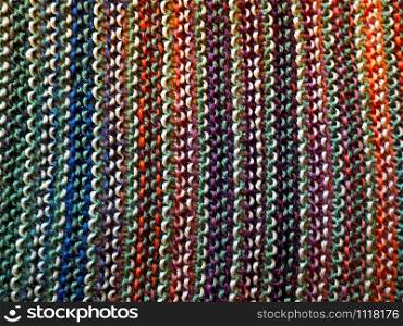 Knitted multicolored fabric texture. Background image. Hobbies, leisure, crafts. Vertical arrangement of the pattern. Knitting. Knitted multicolored fabric. Knitting texture. Background image. Hobbies leisure crafts.