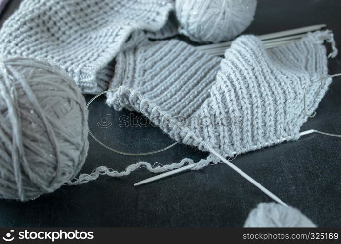 Knitted products on a black background close-up.