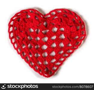 Knitted red heart made of yarn. White isolated
