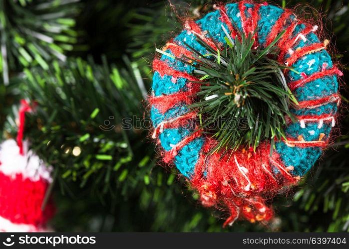 Knitted toy on Christmas tree, close up. Knitted toy on Christmas tree