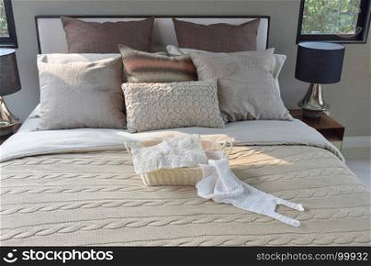 Knitting basket on warm classic style bedding with many texture of pillows