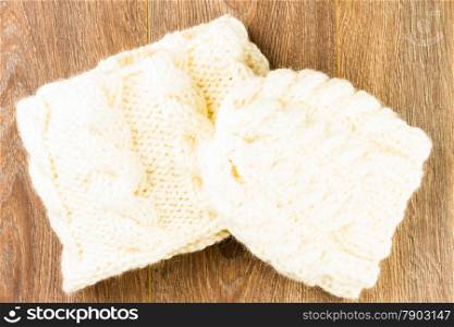 knitting cap and scarf on wooden background