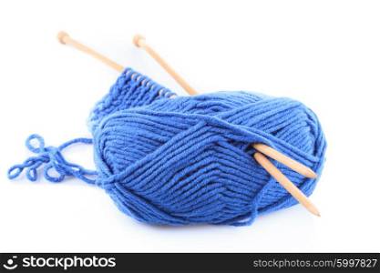 Knitting close up with blue woven thread isoalated on white. Blue knitting isolated