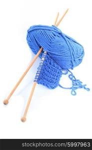 Knitting close up with blue woven thread isoalated on white. Blue knitting isolated
