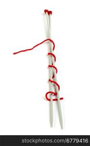 Knitting skewers and red yarn white isolated