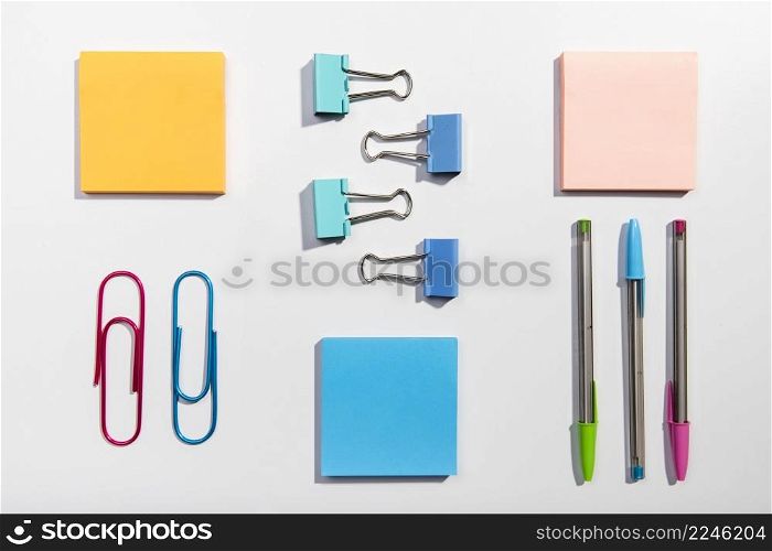 knolling concept with sticky notes paper clips