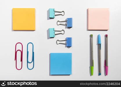 knolling concept with sticky notes paper clips