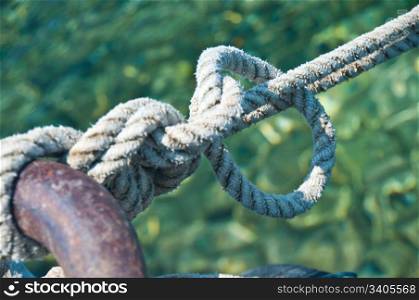 Knot on a metallic ring holding the boat in the harbour - shallow DOF