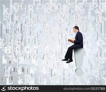 Knowledge concept. Businessman with book sitting on top of exclamation mark