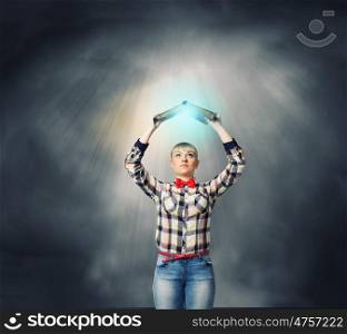 Knowledge concept. Young woman in shirt holding book above head