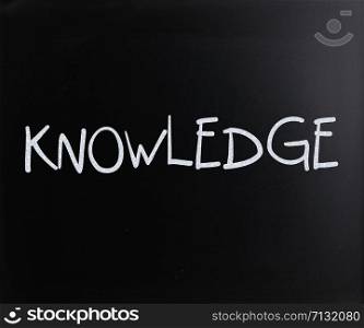 ""Knowledge" handwritten with white chalk on a blackboard"
