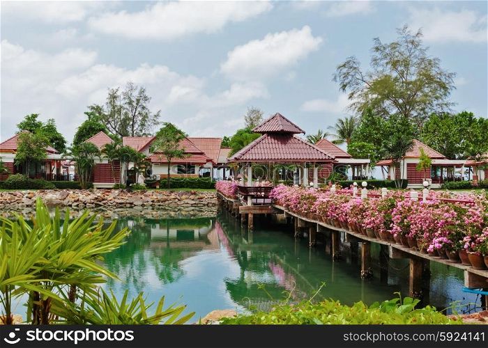 KOH CHANG, THAILAND - 31 MART, 2015: Klong Prao Resort. Bridge with flowers across the bay in a tropical garden