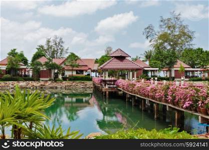 KOH CHANG, THAILAND - 31 MART, 2015: Klong Prao Resort. Bridge with flowers across the bay in a tropical garden