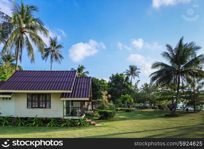 KOH CHANG, THAILAND - APRIL 2, 2015: Bailan Beach Resort. Cottages on the green lawn in a tropical garden