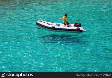 KOH CHANG, THAILAND - MART 30, 2015: National Park Mu Ko Chang.The teenager in a rubber boat