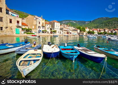Komiza on Vis island turquoise waterfront, boats and town view, Dalmatia, Croatia