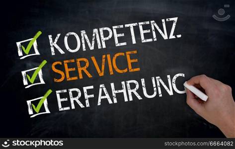Kompetenz, Service, Erfahrung (in german Competence, service, experience) is written by hand on blackboard:. Kompetenz, Service, Erfahrung (in german Competence, service, experience) is written by hand on blackboard