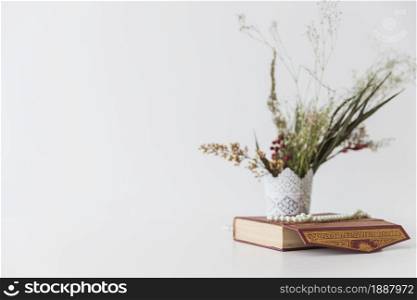 koran book flowers vase . Resolution and high quality beautiful photo. koran book flowers vase . High quality and resolution beautiful photo concept